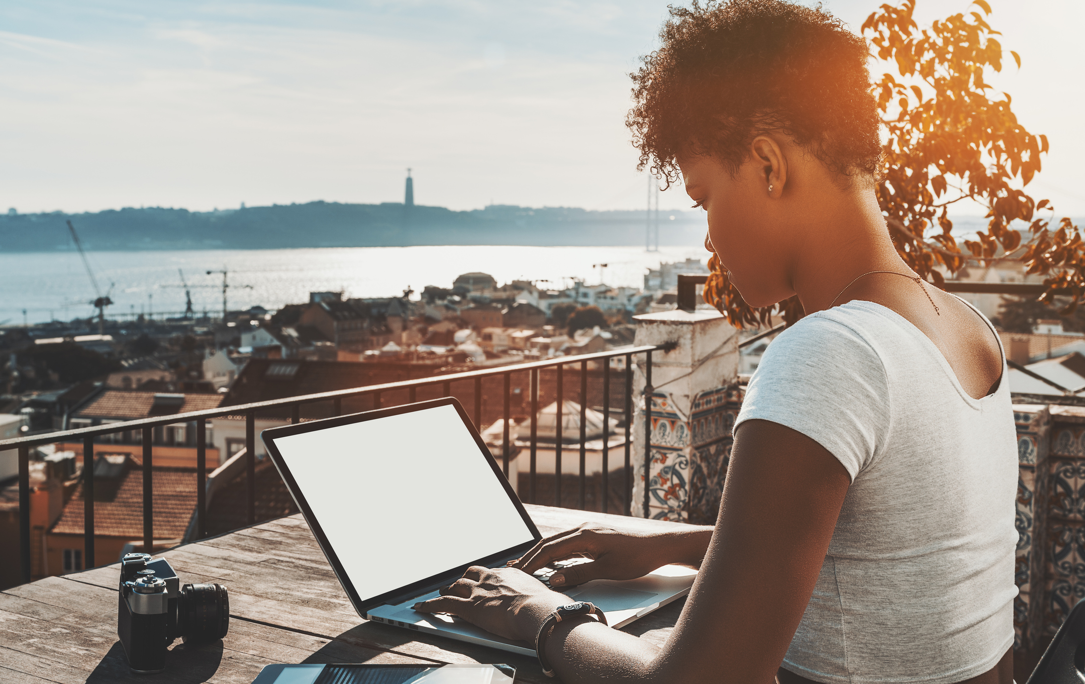 black curly girl with laptop template and retro photo camera